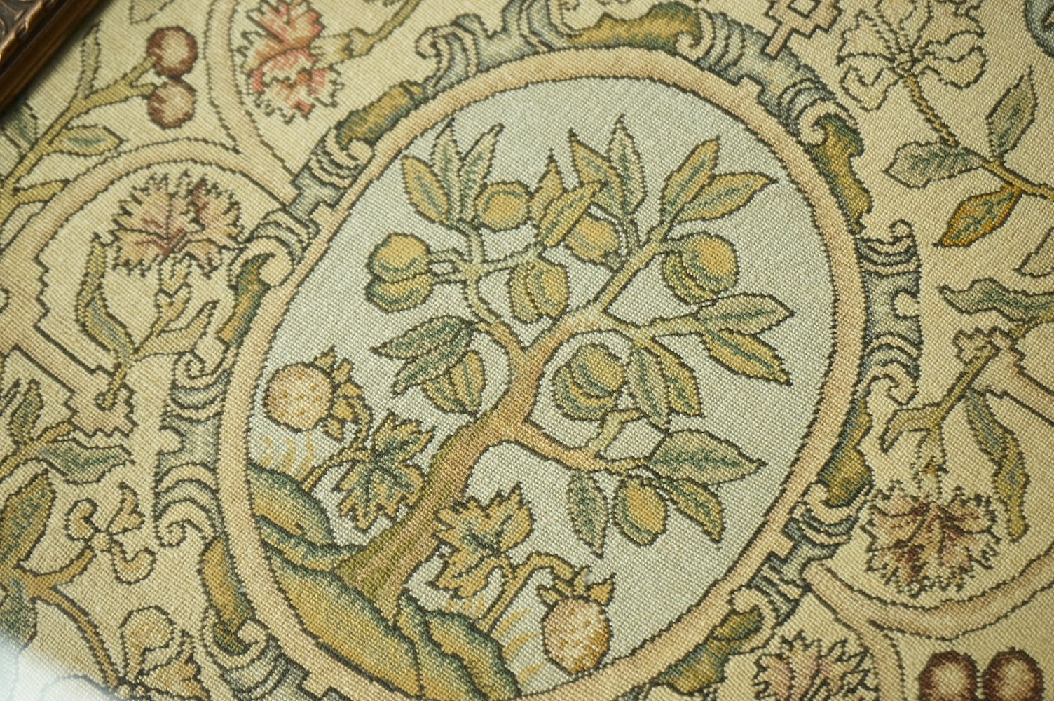 A 20th century framed fine petit point panel, worked with a framed central cartouche of a fruit tree, surrounded by an ornate vining fruit border. 25cm wide x 31cm high. Condition - all the colours and threads are strong
